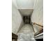 Concrete basement stairs with a wooden handrail lead down at 1410 E 8Th St, Anderson, IN 46012