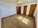 Bedroom with hardwood floors, ceiling fan, and a window offering natural light at 1410 E 8Th St, Anderson, IN 46012