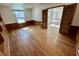 Bedroom features hardwood floors, a window, and an entrance to another room at 1410 E 8Th St, Anderson, IN 46012