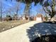 Charming single-story home with brick facade, attached garage and long concrete driveway at 1410 E 8Th St, Anderson, IN 46012