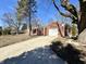 Charming single-story home with brick facade, attached garage and long concrete driveway at 1410 E 8Th St, Anderson, IN 46012