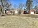Charming single-story home with brick facade, attached garage, and well-maintained lawn at 1410 E 8Th St, Anderson, IN 46012