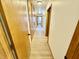 Hallway view featuring hardwood floors and wood doors leading to various rooms in the home at 1410 E 8Th St, Anderson, IN 46012