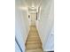Hallway with white brick accent wall and light hardwood flooring at 1410 E 8Th St, Anderson, IN 46012