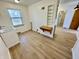 Bright kitchenette features white cabinetry, hardwood flooring, utility sink, and shelving at 1410 E 8Th St, Anderson, IN 46012