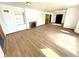 Cozy living room with a fireplace, built-in shelving, and light wood flooring at 1410 E 8Th St, Anderson, IN 46012