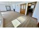 Open-concept living room with fireplace, built-in cabinet, and wood floors at 1410 E 8Th St, Anderson, IN 46012