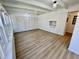 Bright sunroom with wood floors, many windows, a ceiling fan, closet space, and fireplace at 1410 E 8Th St, Anderson, IN 46012