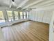 Bright sunroom with wood floors, many windows, a ceiling fan, and closet space at 1410 E 8Th St, Anderson, IN 46012