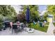 Outdoor patio and backyard with chairs around a fire pit and blue garage at 1424 S New Jersey St, Indianapolis, IN 46225