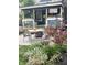 Cozy backyard patio with outdoor seating, a covered porch, and beautiful garden landscaping at 1424 S New Jersey St, Indianapolis, IN 46225