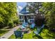 Picturesque backyard featuring a fire pit, blue chairs, and lush greenery at 1424 S New Jersey St, Indianapolis, IN 46225