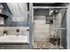 Modern bathroom featuring a tub, stylish tile work, and a glass-enclosed shower with stone flooring at 1424 S New Jersey St, Indianapolis, IN 46225