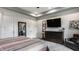Well-lit bedroom with a striped comforter, dark wood dresser, and modern decor at 1424 S New Jersey St, Indianapolis, IN 46225