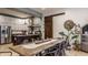 Dining area featuring modern appliances, a kitchen, a long table, and a rustic barn door at 1424 S New Jersey St, Indianapolis, IN 46225