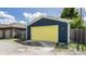 View of the detached blue garage with yellow door at 1424 S New Jersey St, Indianapolis, IN 46225