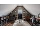 Bright home office in finished attic with hardwood floors, a large rug, and multiple work spaces at 1424 S New Jersey St, Indianapolis, IN 46225