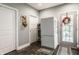 Practical kitchen area with a white refrigerator, storage shelves, and doors leading to other parts of the home at 1424 S New Jersey St, Indianapolis, IN 46225