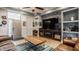 Stylish living room featuring a large TV, built-in fireplace, and comfortable leather sofa at 1424 S New Jersey St, Indianapolis, IN 46225