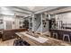 Open-concept living room and kitchen featuring a large wooden dining table and modern stainless steel appliances at 1424 S New Jersey St, Indianapolis, IN 46225
