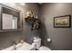Chic powder room featuring decorative shelves, modern fixtures, and stylish gray walls at 1424 S New Jersey St, Indianapolis, IN 46225