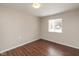 This bedroom features hardwood floors, neutral walls, and a window for natural light at 1431 W Edgewood Ave, Indianapolis, IN 46217