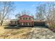 Two-story home featuring a two-car garage, brick accents, and a long driveway at 1431 W Edgewood Ave, Indianapolis, IN 46217