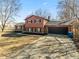 Two-story home featuring a two-car garage, brick accents, and a long driveway at 1431 W Edgewood Ave, Indianapolis, IN 46217