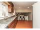 Kitchen with stainless steel sink, wood cabinets, granite countertops, and wood floors at 1431 W Edgewood Ave, Indianapolis, IN 46217