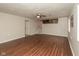 Open living room with wood flooring and staircase to the kitchen at 1431 W Edgewood Ave, Indianapolis, IN 46217