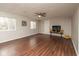 Spacious living room with wood flooring, ceiling fan, and fireplace at 1431 W Edgewood Ave, Indianapolis, IN 46217