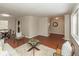 Living room featuring hardwood floors, large windows, and access to the dining area at 1431 W Edgewood Ave, Indianapolis, IN 46217