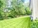 A spacious backyard features a lush lawn, mature trees, and a well-maintained fence, offering serene outdoor living at 1470 Northern Valley Trl, Avon, IN 46123