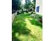 Well-maintained backyard with lush green lawn, garden beds, and sprinkler system at 1470 Northern Valley Trl, Avon, IN 46123