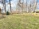 Open backyard featuring sparse grass, bare trees, and a wooden fence at 1470 Northern Valley Trl, Avon, IN 46123