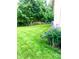 Spacious backyard with lush lawn, mature trees, and flower beds at 1470 Northern Valley Trl, Avon, IN 46123