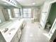 Bright bathroom features dual sinks, tile floors, a glass enclosed shower and a large soaking tub at 1470 Northern Valley Trl, Avon, IN 46123