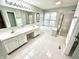 Bright bathroom features dual sinks, tile floors, a glass enclosed shower and a large soaking tub at 1470 Northern Valley Trl, Avon, IN 46123