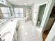 Bright bathroom features dual sinks, tile floors, a glass enclosed shower and a large soaking tub at 1470 Northern Valley Trl, Avon, IN 46123