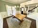 Dining room has green accent wall, a modern chandelier, and large windows for ample light at 1470 Northern Valley Trl, Avon, IN 46123