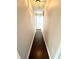 Hallway features hardwood floors and a neutral color scheme, leading to various rooms in the house at 1470 Northern Valley Trl, Avon, IN 46123