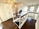 Upstairs hallway with hardwood floors and views of the staircase at 1470 Northern Valley Trl, Avon, IN 46123