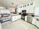 Open kitchen with stainless steel appliances connected to the living room at 1470 Northern Valley Trl, Avon, IN 46123