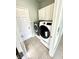 Laundry room with white cabinets, tile floor, and front load washer and dryer at 1470 Northern Valley Trl, Avon, IN 46123