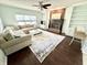 Bright living room boasts a brick fireplace, ceiling fan, and large sectional sofa at 1470 Northern Valley Trl, Avon, IN 46123
