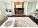Living room featuring a cozy brick fireplace and built in shelving at 1470 Northern Valley Trl, Avon, IN 46123