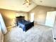Spacious bedroom with a ceiling fan, neutral walls, carpet floors, and a black bed at 1470 Northern Valley Trl, Avon, IN 46123