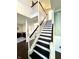 Elegant staircase with a dark wood floor and white railings at 1470 Northern Valley Trl, Avon, IN 46123
