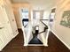 Open staircase with dark hardwood floors and white railings, leading to various rooms on the upper level at 1470 Northern Valley Trl, Avon, IN 46123