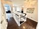 Open foyer with dark hardwood floors and staircase with white railings, leading to the upper level at 1470 Northern Valley Trl, Avon, IN 46123